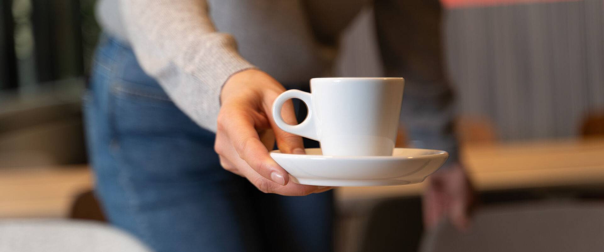 Someone who brings another person a cup of coffee